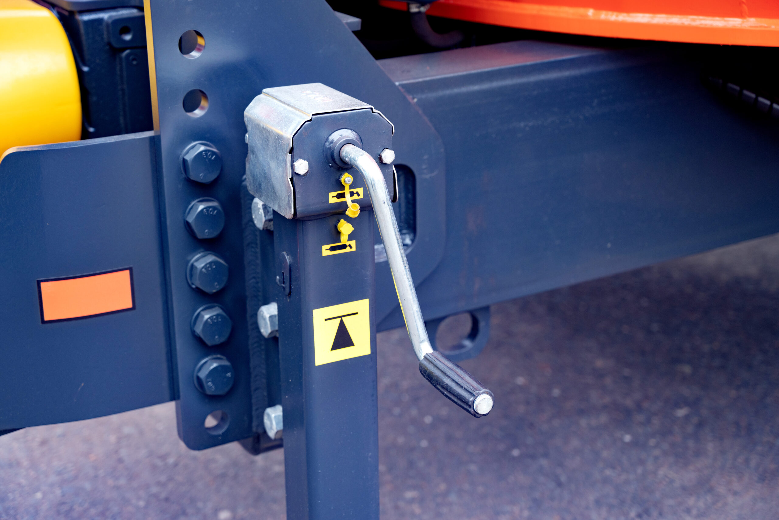 Close-up of a mechanical crank handle on a trailer jack stand. Close-up of a mechanical crank handle on a trailer jack stand.
